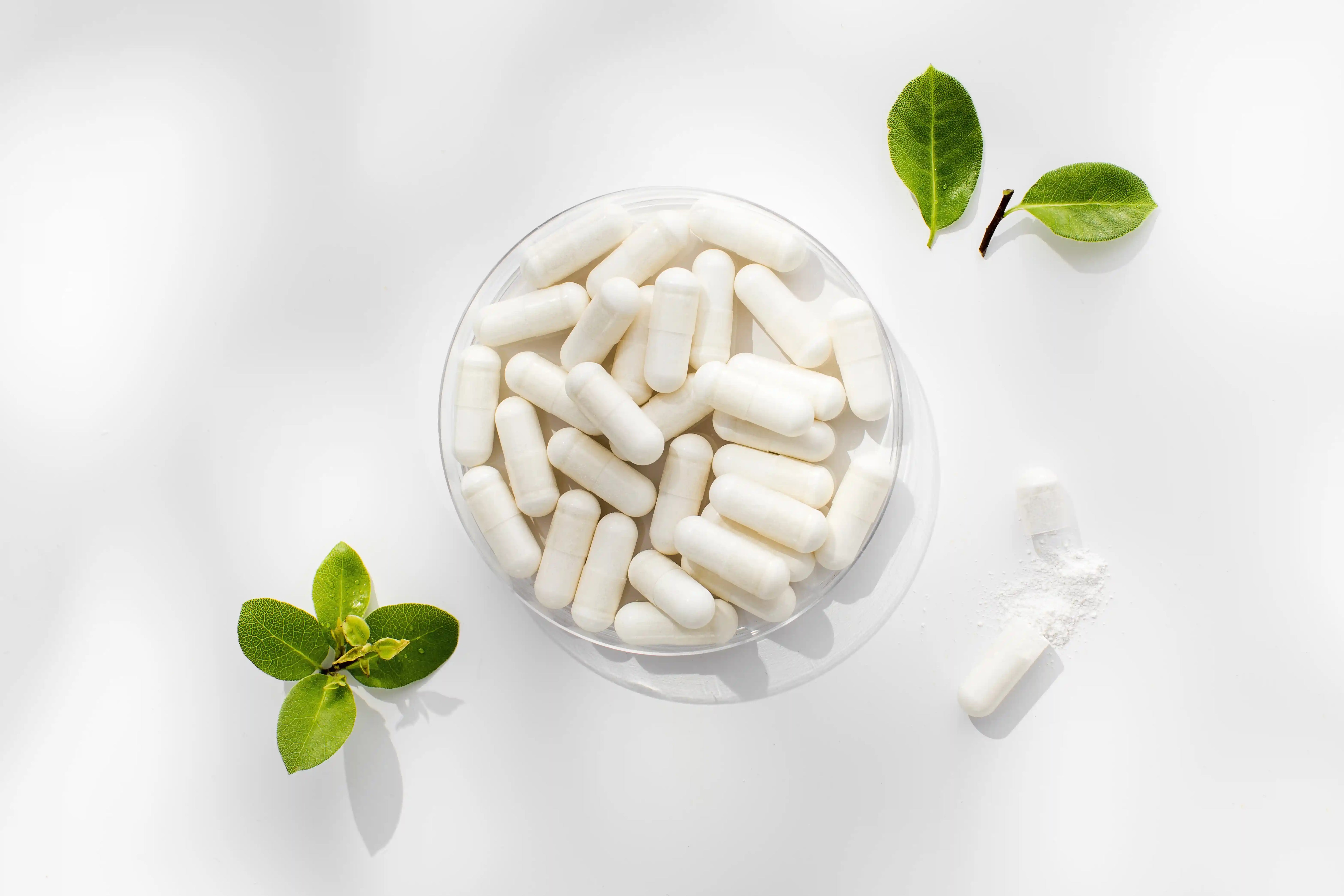 bowl of white capsules filled with magnesium