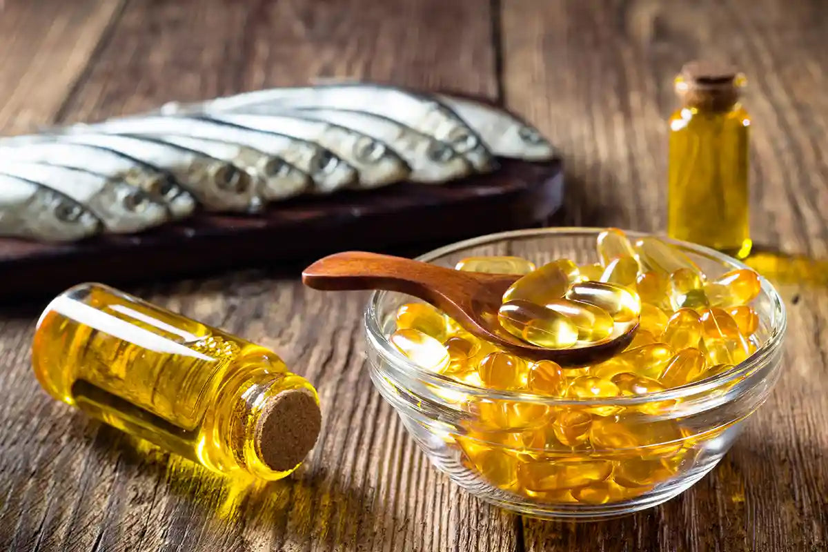 fish oil softgels and oil on a wooden plank